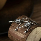 Kolczyki wiszące z buddyjskim kołem modlitewnym