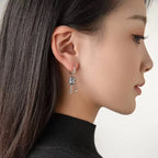 Kolczyki wiszące z buddyjskim kołem modlitewnym