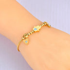 Bransoletka ochronna z ręką Fatimy i niebieskim okiem złota