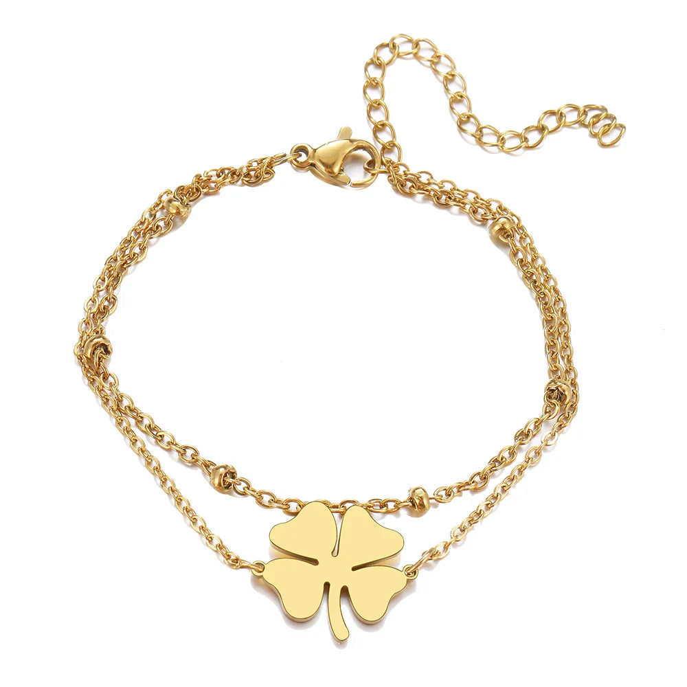 Dobbelt armbånd med firkløver i guld